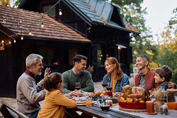 istock Happy multi-generation family enjoying in conversation while gathering on Thanksgiving. 2243828260