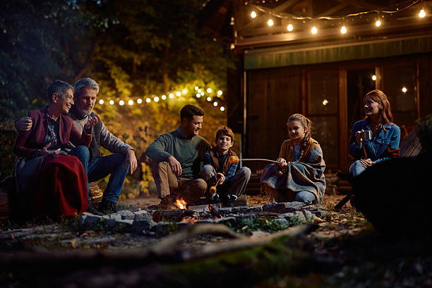 istock Happy extended family roasting corn on fire on autumn evening. 2243828718