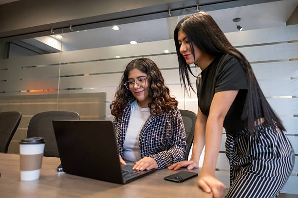 istock young female executives working happily and diligently in a modern office environment using their laptop and phone 2243828894