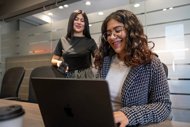 istock young female executives working happily and diligently in a modern office environment using their laptop and phone 2243829702