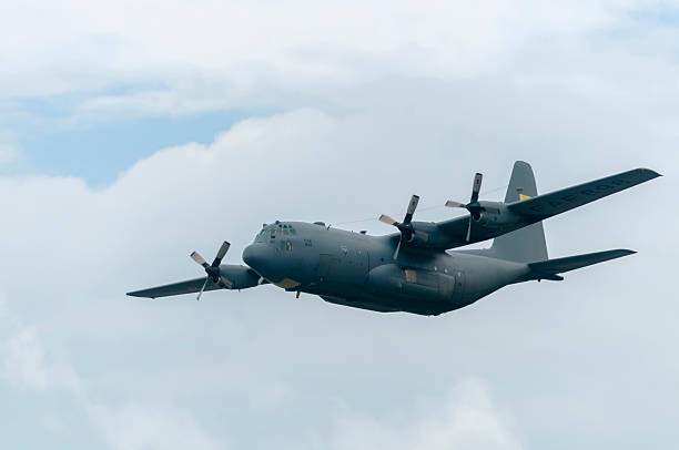 Impressive C-130 Hercules aircraft of the Ecuadorian Air Force (FAE) crossing the partly cloudy sky. This robust military transport aircraft symbolizes logistics and air power.