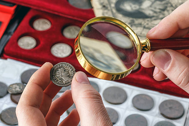 istock Numismatics.Authentic silver denarius, antoninianus of ancient Rome. A collector holds an old coin.Ancient coin of the Roman Empire.Magnifying glass 2243829940