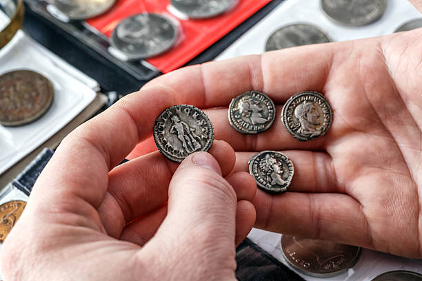istock Numismatics.Authentic silver denarius, antoninianus of ancient Rome. A collector holds an old coin.Ancient coin of the Roman Empire.Magnifying glass 2243829970