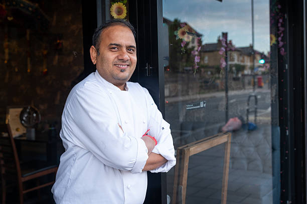 istock Indian restaurant chef smiling outside entrance 2243830150