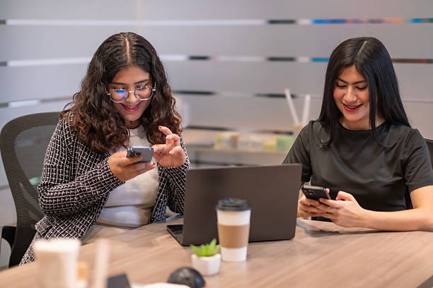 istock young female executives working happily and diligently in a modern office environment using their laptop and phone 2243830414