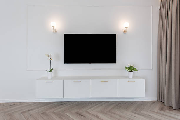 istock Modern Home Living Room with Wall-Mounted TV and Minimalistic Interior Decor 2243830719