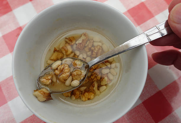 Mustard vinaigrette dressing with pine nuts and walnuts