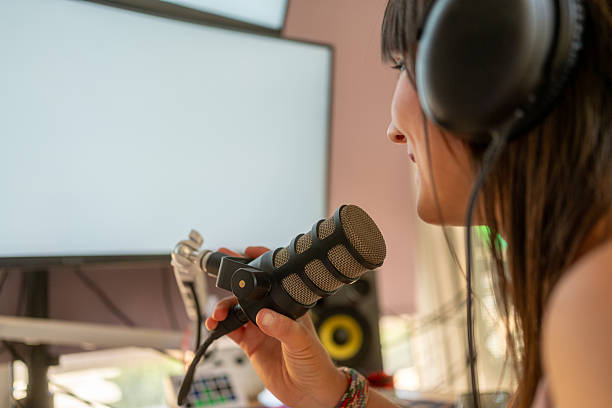 istock Woman recording podcast at home studio speaking into microphone 2243832902