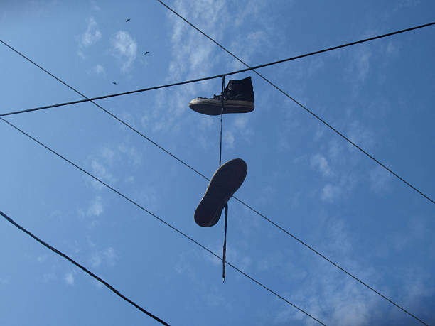 istock Sneaker Shoes Hanging from Telephone Wires 2243836293