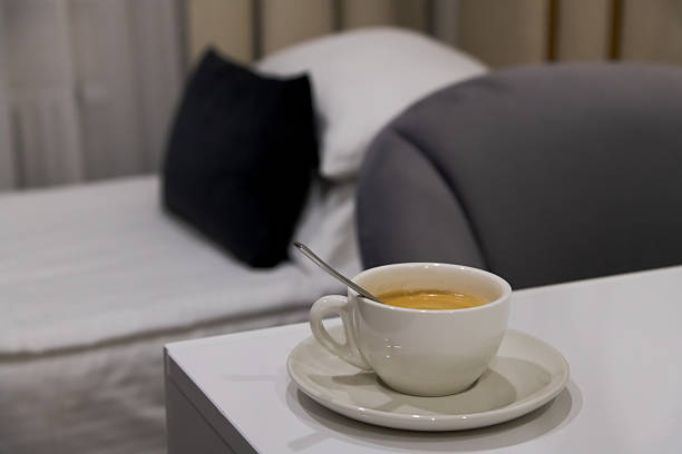 A woman enjoys orange juice and breakfast in the hotel lounge provided by the hotel staff.