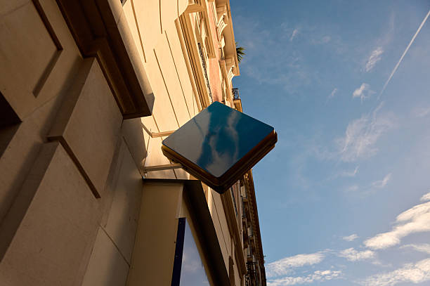 Blank blue rhombus store sign on building exterior creating space for copy