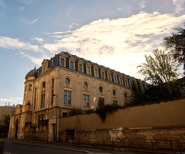 Facade and courtyard of Caves du Couvant des Cordeliers. Built as a monastery in 1243, it now houses a wine merchant. The cellars are situated in the historic heart of Beaune and are very popular for Burgundy wine tasting.