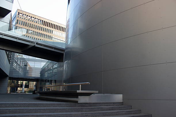 istock Modern architecture with curved metal wall and glass buildings 2243841712