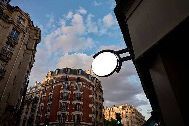 Blank round sign offering ad space on a building exterior in paris