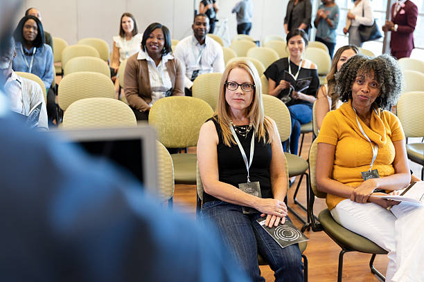 istock Diverse group of people attending a conference or educational event indoors, focused on learning and networking. 2243841872