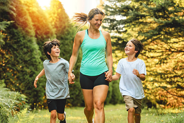istock mother and son running outside in forest 2243844639