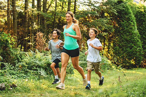 istock mother and son running outside in forest 2243844641