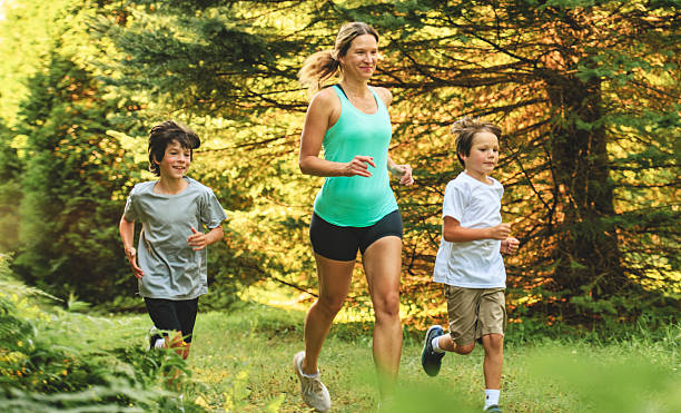 istock mother and son running outside in forest 2243844643
