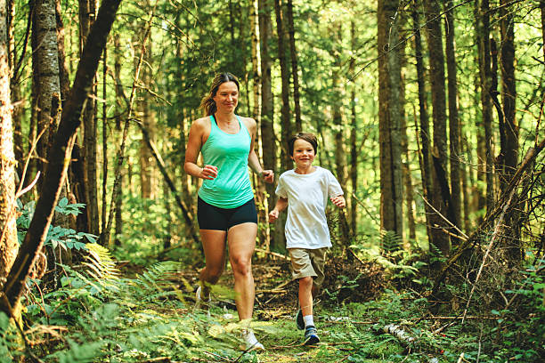 istock mother and son running outside in forest 2243844647