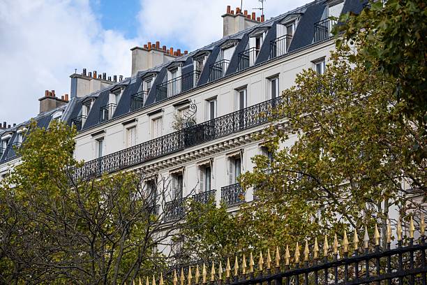 istock Parisian building with classic architecture and autumn trees. 2243844807
