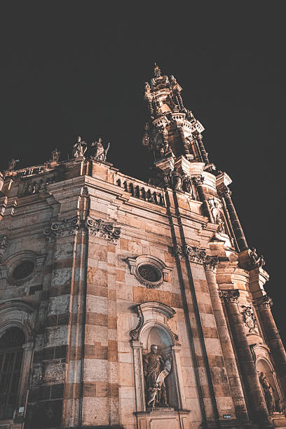 Dresden, Germany Night city lights with tourists walking past restaurants and historic buildings.
