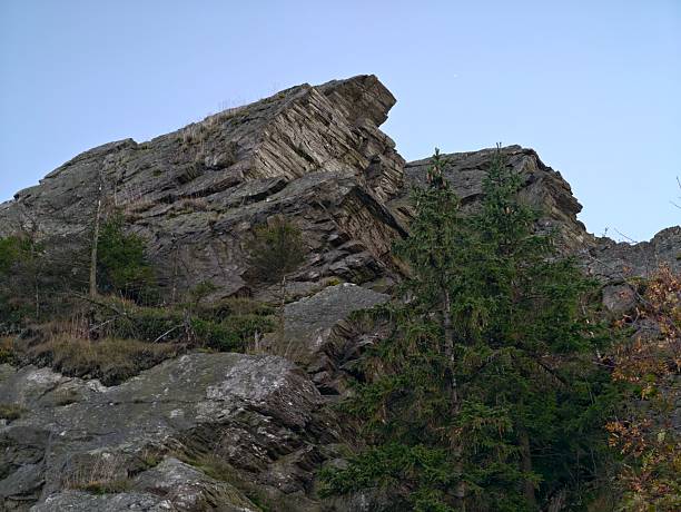 rock ridge solitude, majestic tilted rock formation with solitary pine and dramatic geological