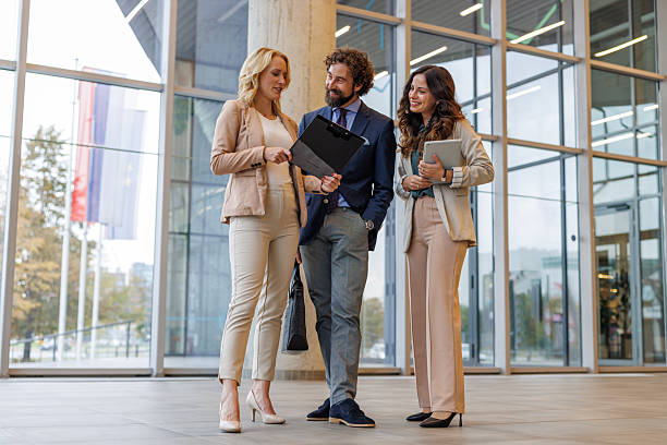 istock Business colleagues discussing project in modern office hallway 2243847849