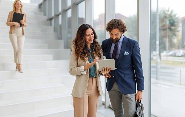 istock Business colleagues discussing project using digital tablet on office stairs 2243847921