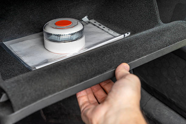 V16 emergency warning beacon in car glove compartment.