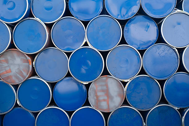 istock Blue and silver metal barrels arranged in rows. 2243850639