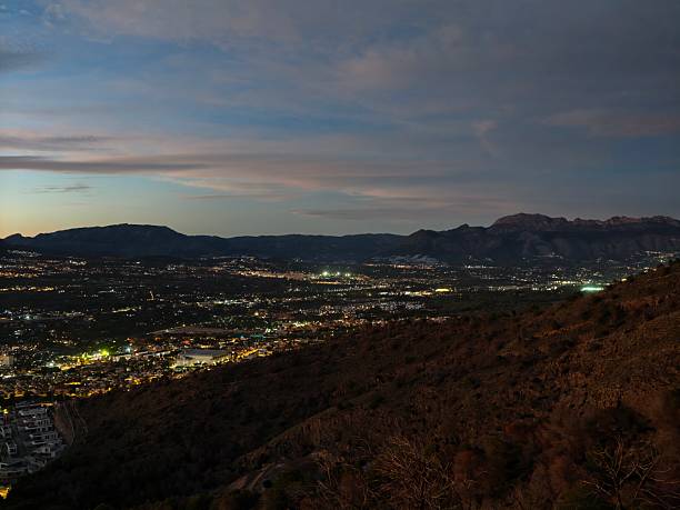 istock captivating hillside vantage point showcasing sparkling urban lights and remote mountain outlines 2243850718