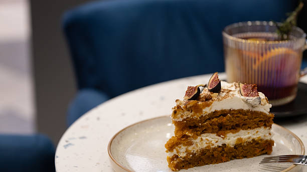 istock Carrot Cake Slice with Figs on a Plate in Cozy Cafe 2243855034