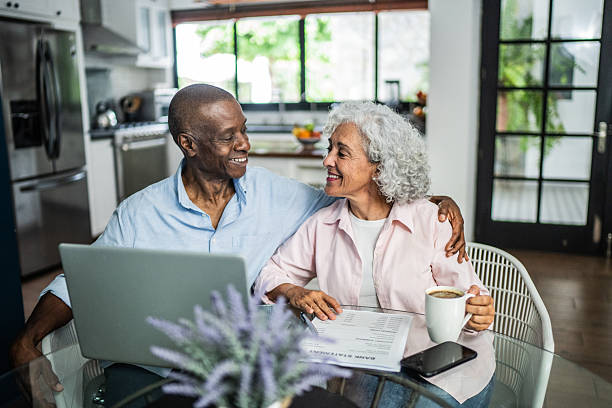 istock American senior couple talking and using laptop at home 2243855349