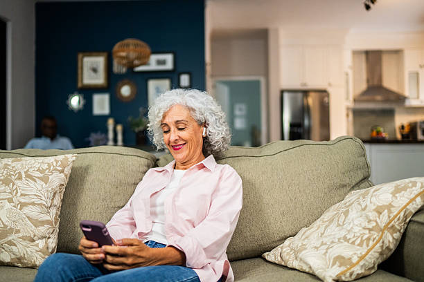 istock American senior woman using mobile phone at home 2243855706