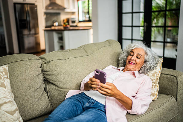 istock American senior woman using mobile phone at home 2243855721
