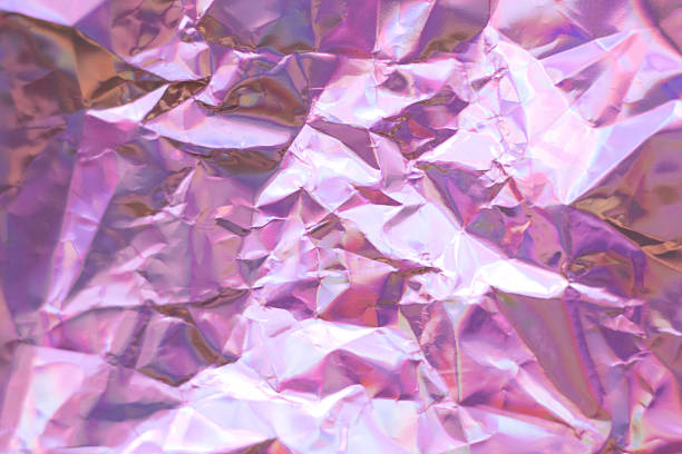 istock Pink crumpled foil texture background with reflective metallic surface for design projects 2243855732