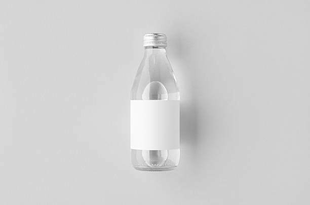 istock Small water bottle mockup with blank label, clear glass 2243856528