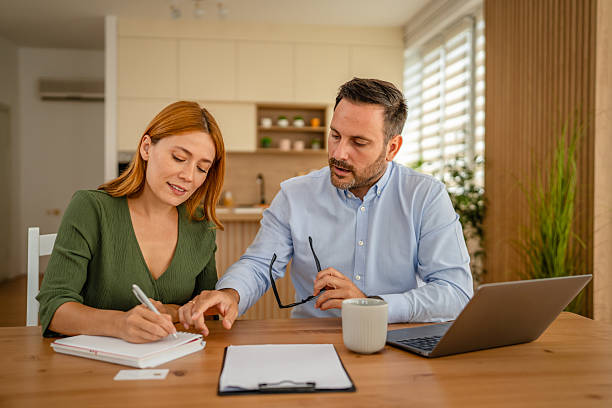 istock Couple calculating expenses together in home office 2243858424