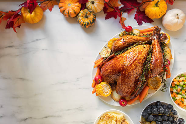 istock Preparing turkey with side dishes for Thanksgiving celebration 2243859189
