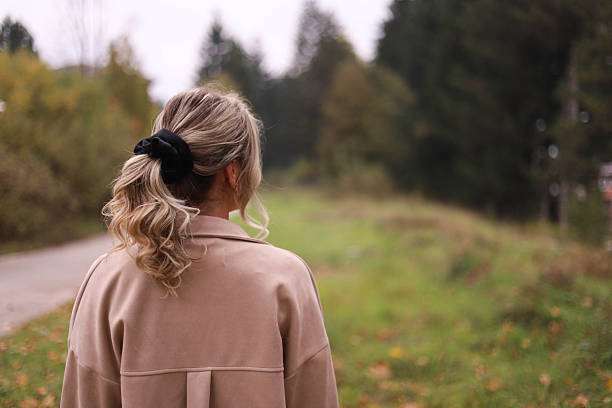 istock Autumn Fashion: Blue-Haired Woman with Hair Scrunchie in Natural Setting 2243859961