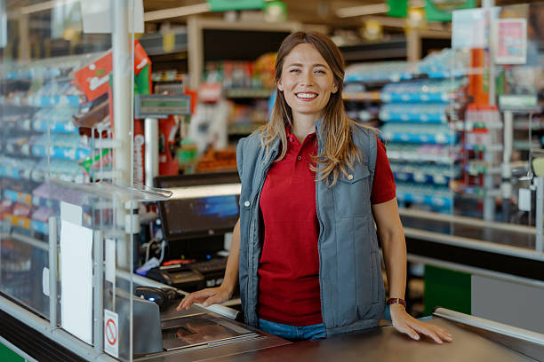 istock Smiling Cashier Working at Supermarket Checkout Counter 2243860198