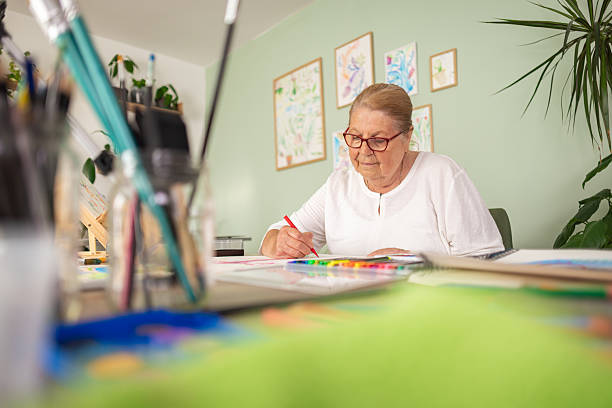 istock Elderly Woman Enjoying Creative Work at Home 2243861828