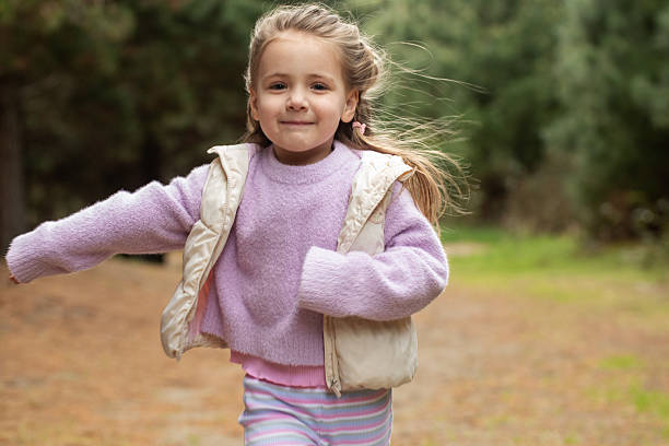 istock Joyful child running in nature's forest pathway. Nature 2243862958