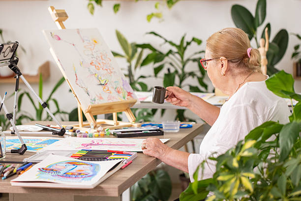 istock Relaxed Mature Woman Taking a Coffee Break in Art Workspace 2243864306