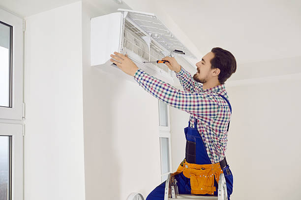 istock Young technician using a screwdriver while repairing an air conditioner on the wall 2243869422