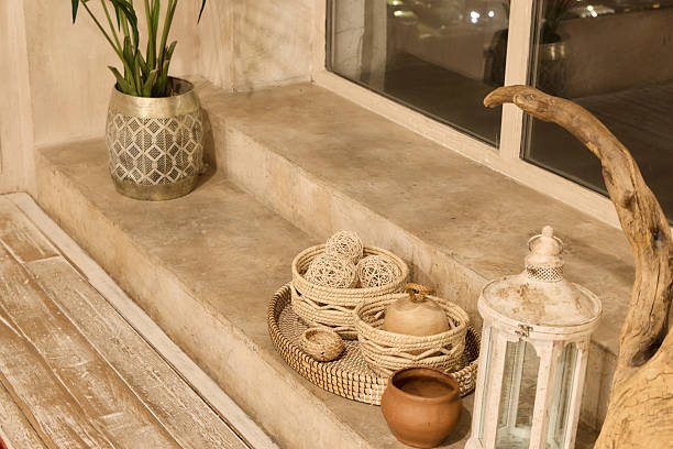 istock A rustic windowsill decor with wicker ornaments, a warm lantern, and a potted plant 2243869635
