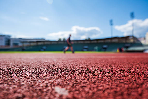 running track for athletic competition, training, exercise in stadium in summer.