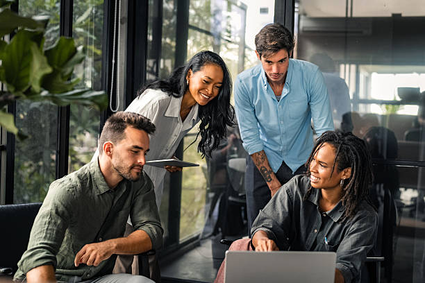 istock Group of young multi-ethnic startup business team collaborating on project in modern office 2243870686