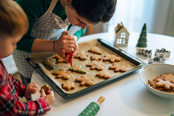 istock Decorating Christmas cookies with colorful icing. 2243874832