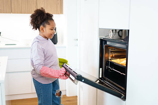 istock Mixed Race Girl Baking in Bright Modern Kitchen 2243875737